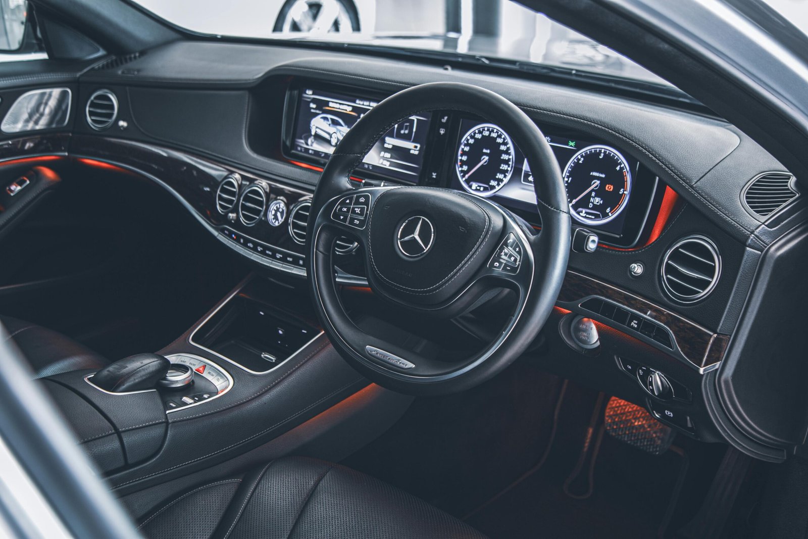 Chauffeur opening car door for businesswoman
